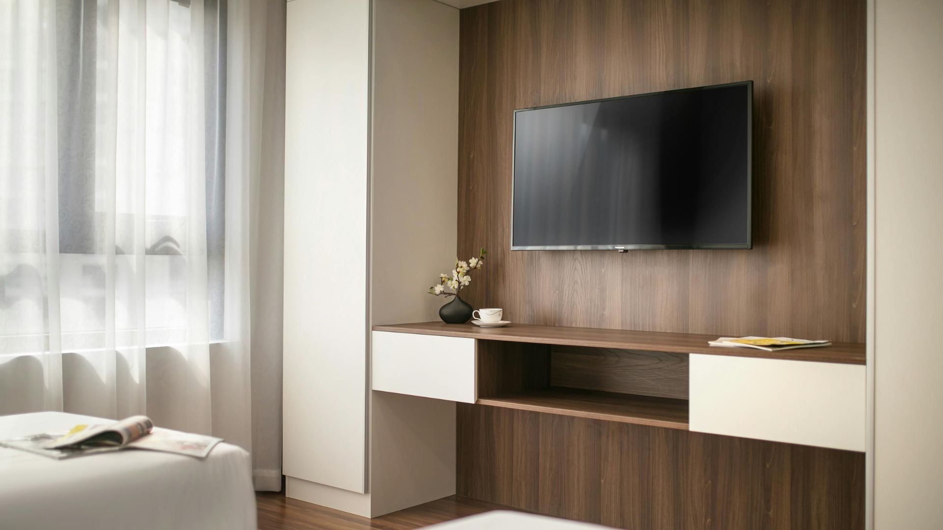 Modern living room with mounted TV, wooden wall, and minimalist decor