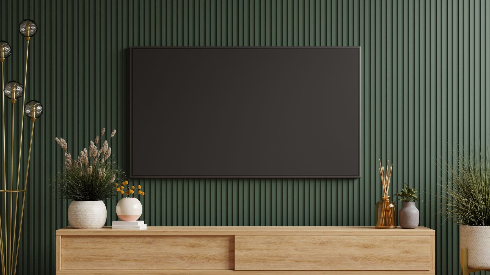 Minimalist living room with black TV, wooden console, and green textured wall