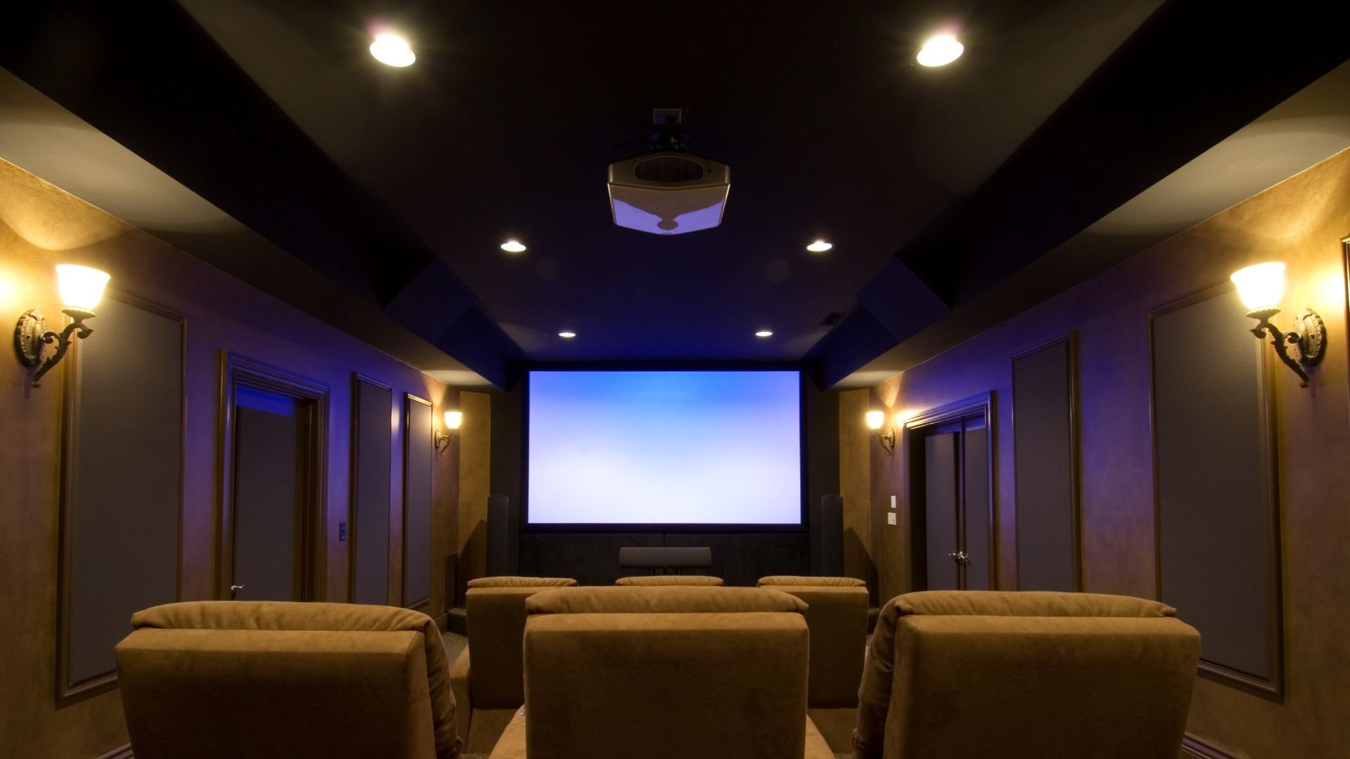 Home theater room with plush seats and large projection screen